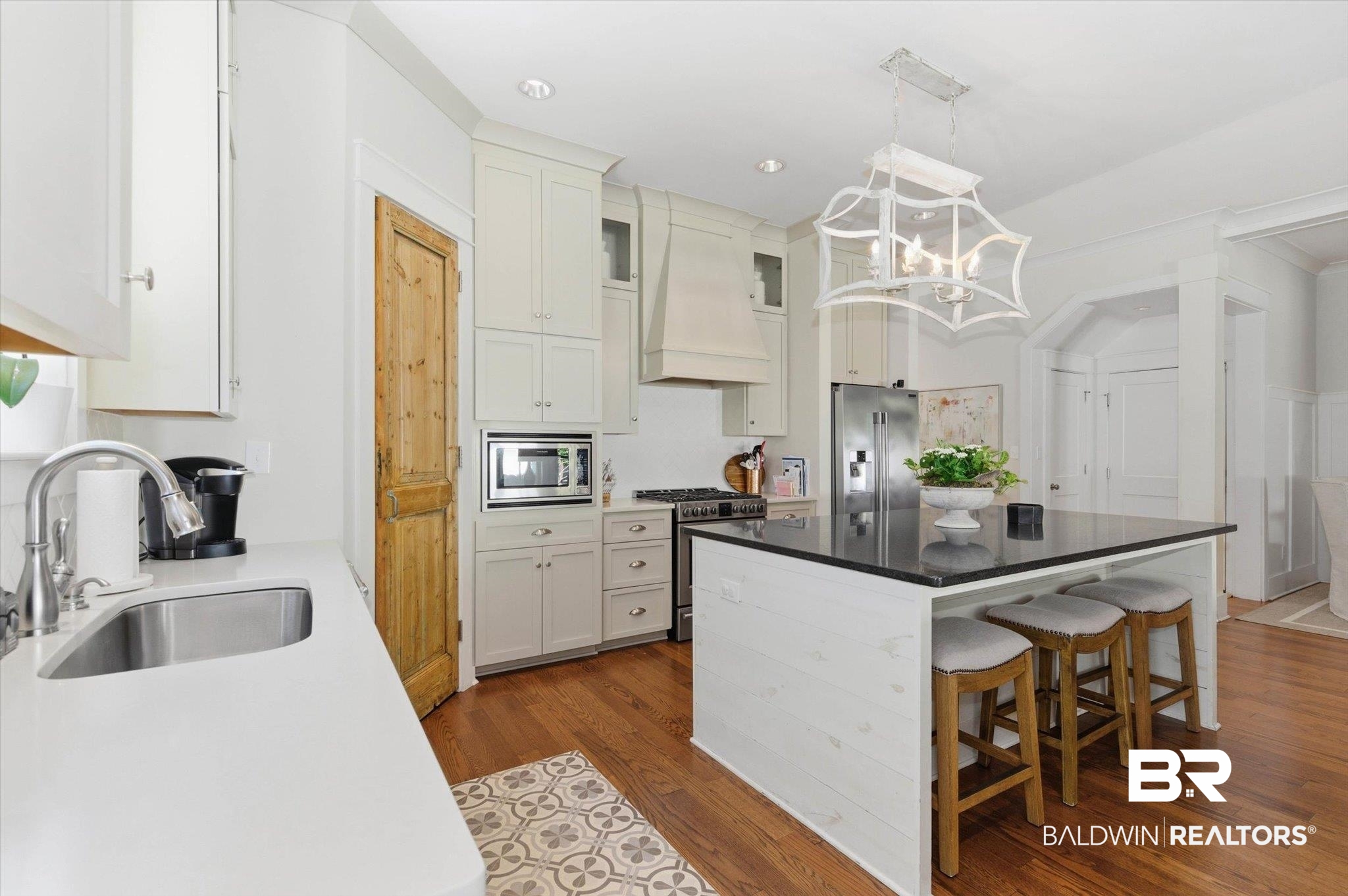 3704 Stein Street Mobile, AL 36608 - Photo 12 of 37 Kitchen with a kitchen breakfast bar, dark stone counters, light wood-style floors, appliances with stainless steel finishes, and pendant lighting