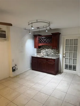 a kitchen with stainless steel appliances kitchen island granite countertop a stove and a sink with granite countertops