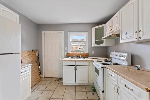 a kitchen with a stove a sink and a refrigerator