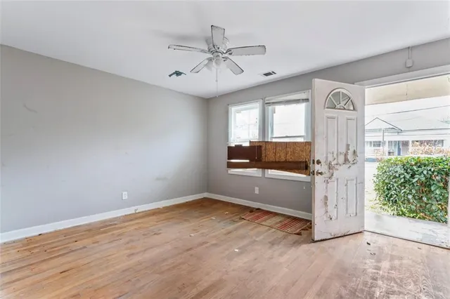 wooden floor in an empty room with a window