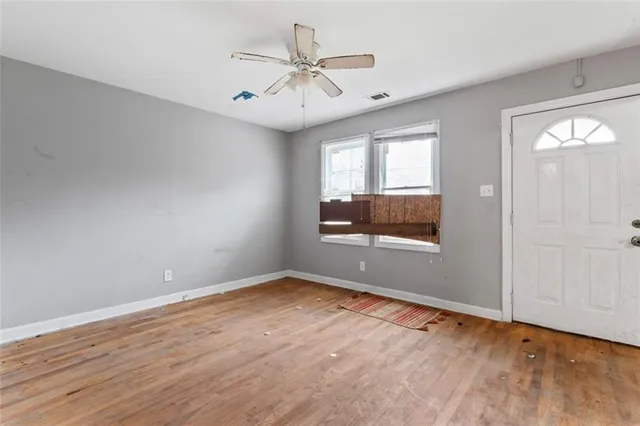 wooden floor in an empty room with a window