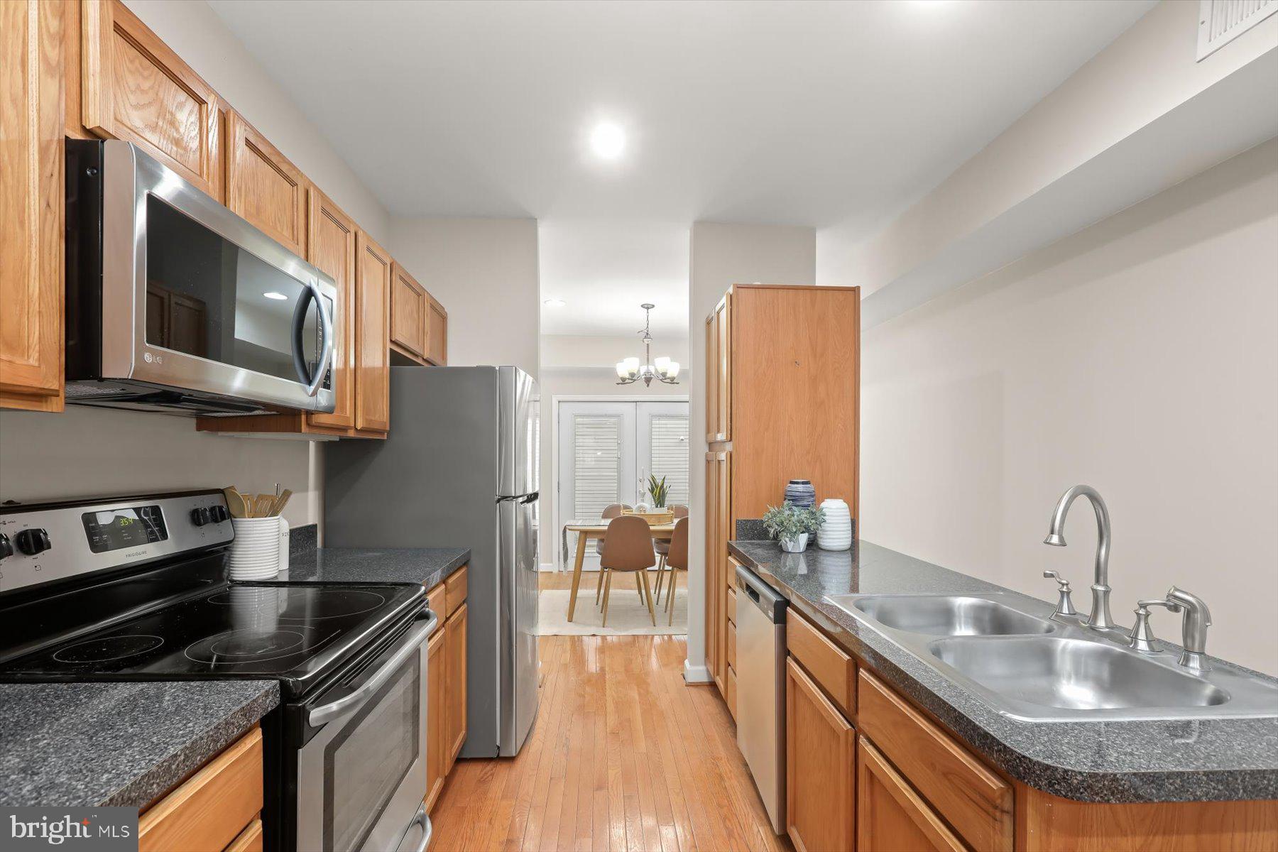 1749 South Hanover Street Baltimore, MD 21230 - Photo 11 of 55 a kitchen with stainless steel appliances granite countertop a sink stove and refrigerator