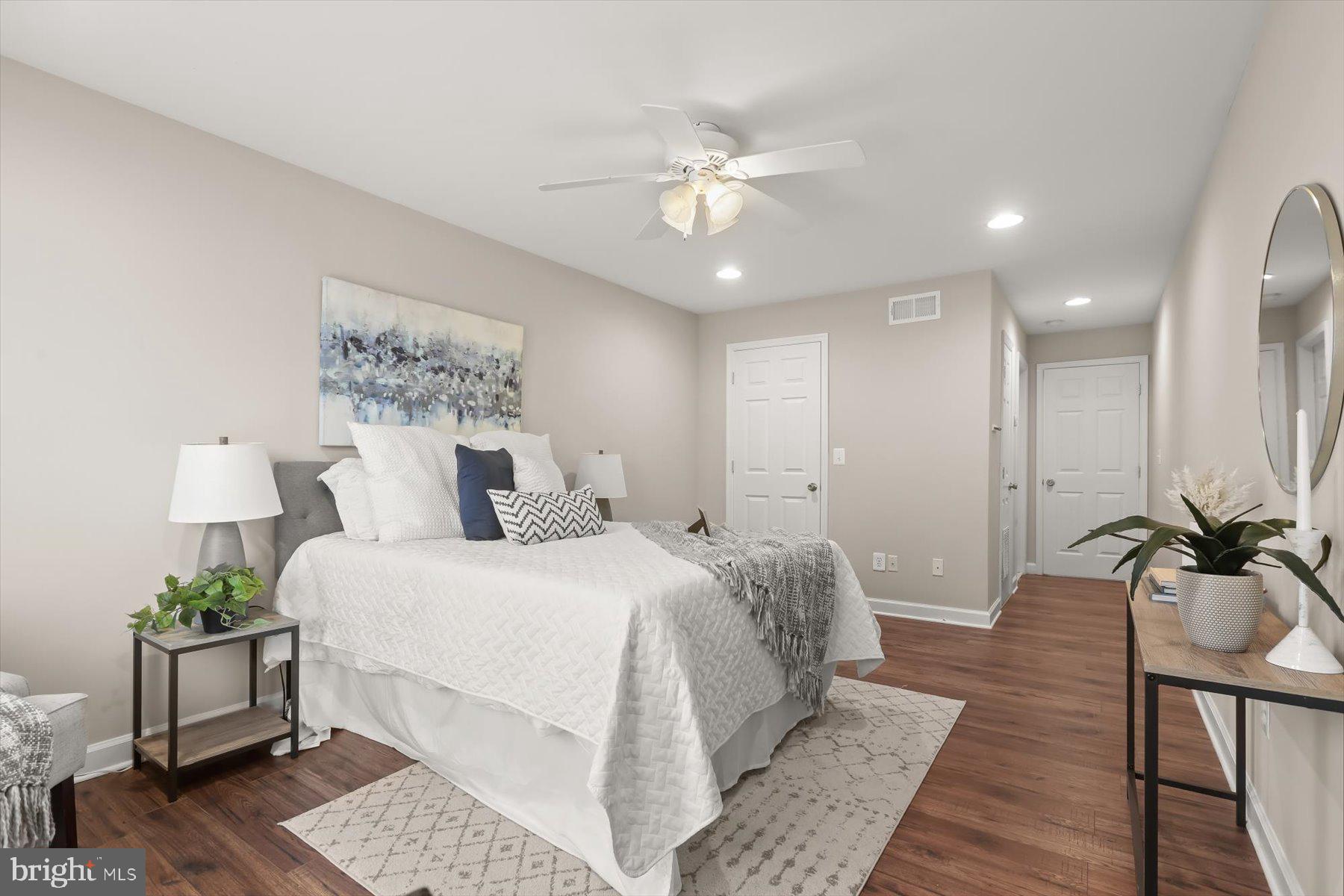 1749 South Hanover Street Baltimore, MD 21230 - Photo 16 of 55 a spacious bedroom with a bed and a chandelier