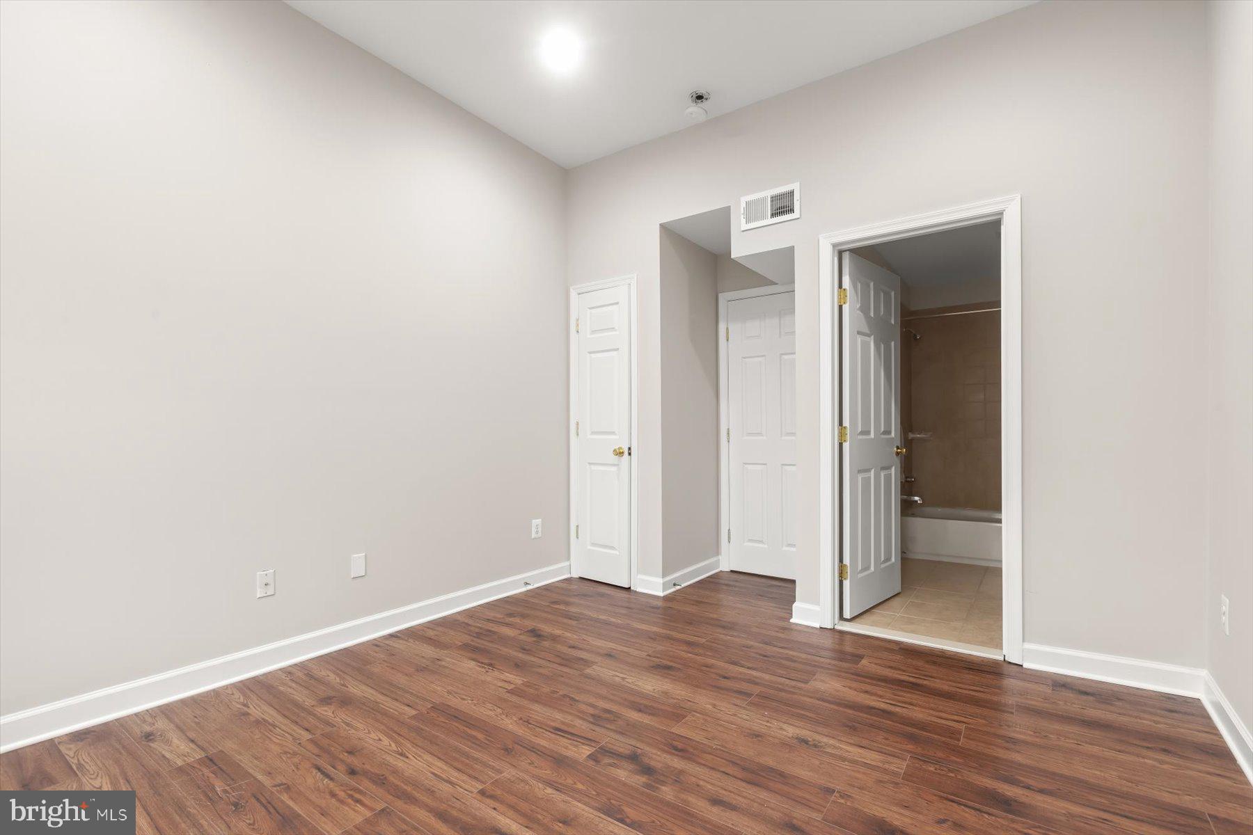1749 South Hanover Street Baltimore, MD 21230 - Photo 23 of 55 a view of an empty room with wooden floor and closet