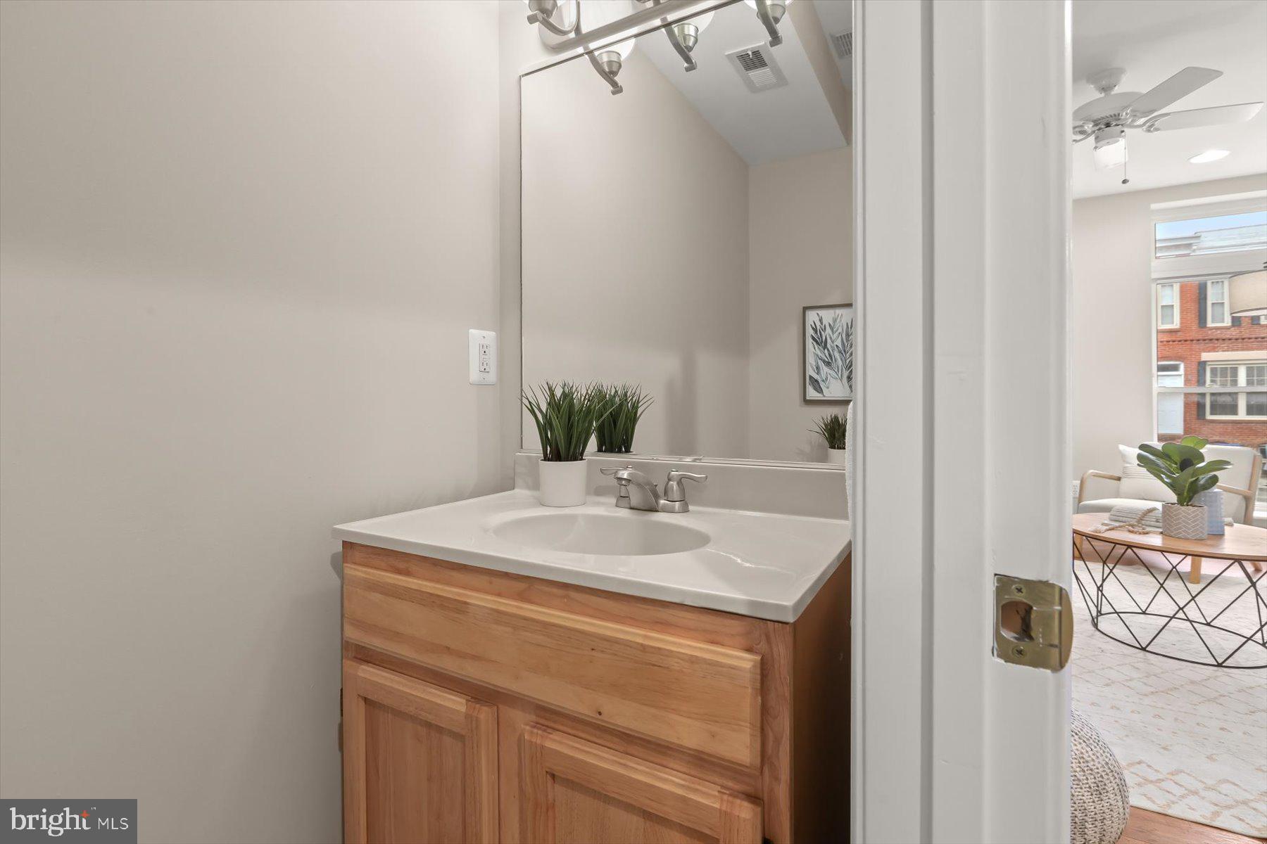 1749 South Hanover Street Baltimore, MD 21230 - Photo 6 of 55 a bathroom with a sink and a mirror