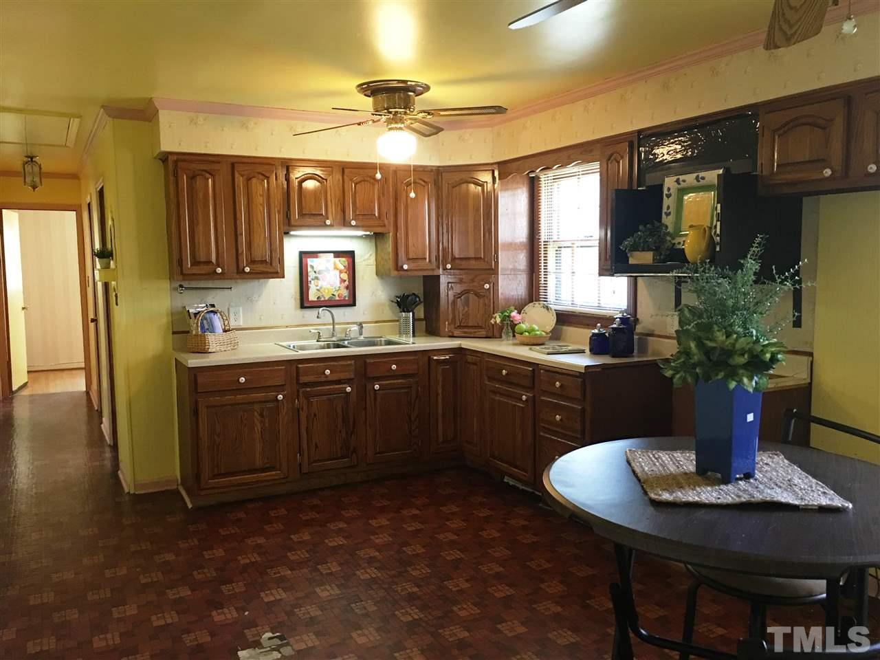 202 Lancaster Road Mebane, NC 27302 - Photo 4 of 9 a kitchen with a sink and a refrigerator
