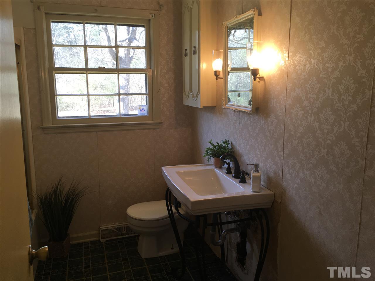 202 Lancaster Road Mebane, NC 27302 - Photo 7 of 9 a bathroom with a sink a toilet and mirror