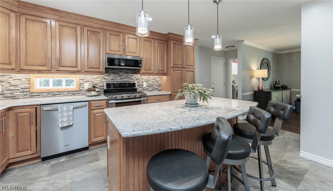 4511 Ranchwood Road Akron, OH 44333 - Photo 2 of 38 Recently remodeled kitchen with Cambria quartz counters, tile backsplash and tiled floors.