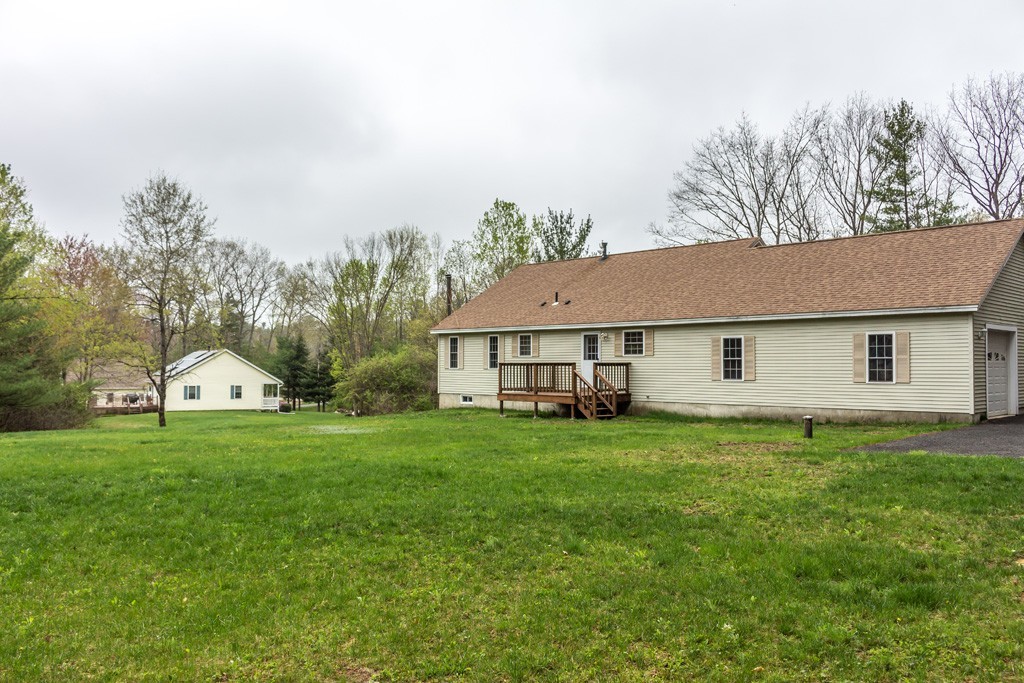 5294 South Athol Road Athol, MA 01331 - Photo 13 of 13 a house that is sitting in the grass with large trees and plants