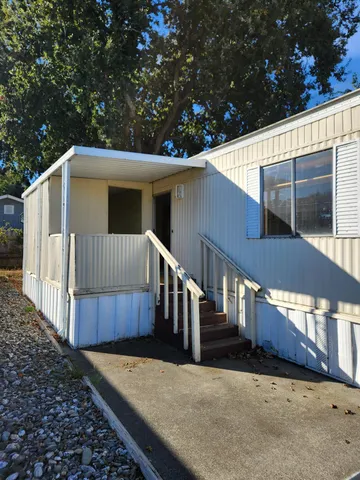 a view of a house with wooden fence
