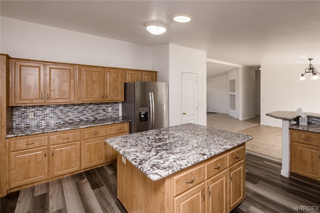 1949 Growler Road Golden Valley, AZ 86413 - Photo 24 of 87 a kitchen with kitchen island granite countertop a stove and a sink