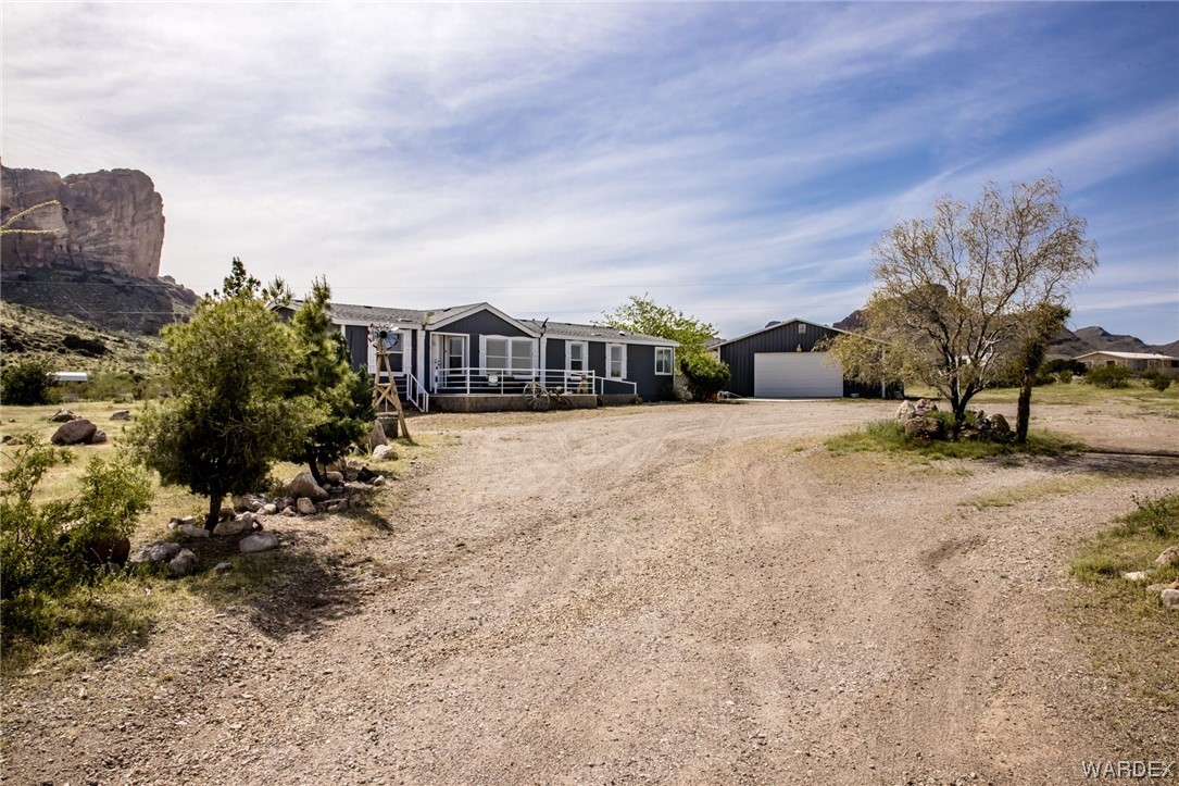 1949 Growler Road Golden Valley, AZ 86413 - Photo 59 of 87 a view of a house with a yard and large trees