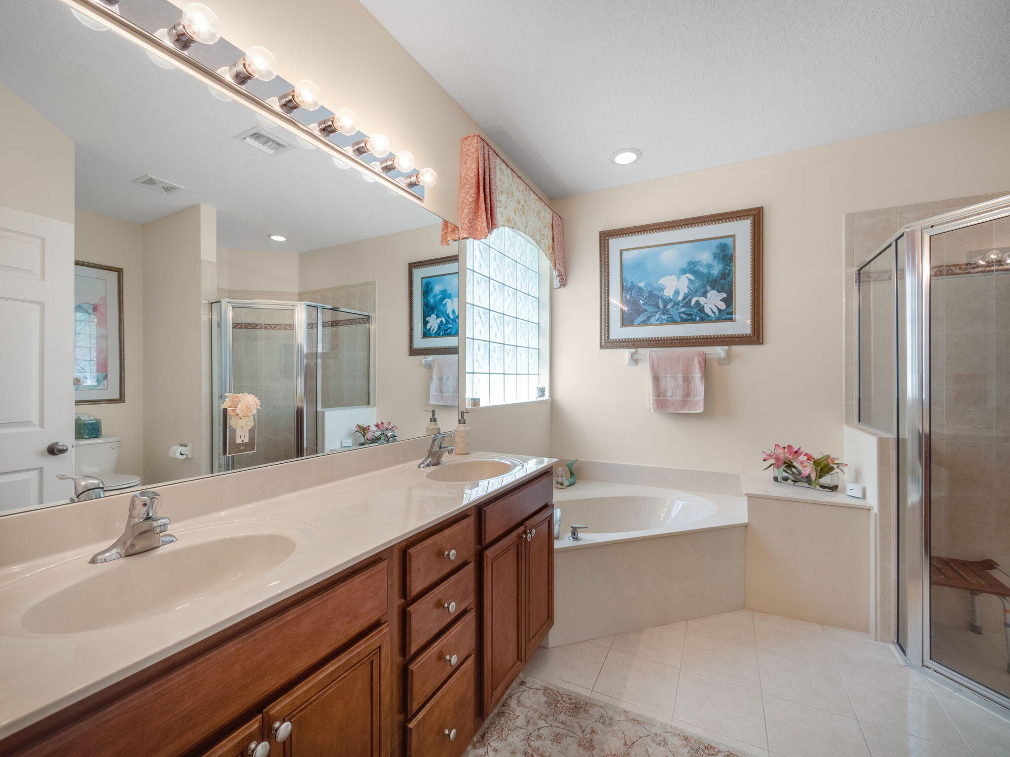 204 Clocktower Drive Jupiter, FL 33458 - Photo 11 of 21 a bathroom with a tub sink and mirror