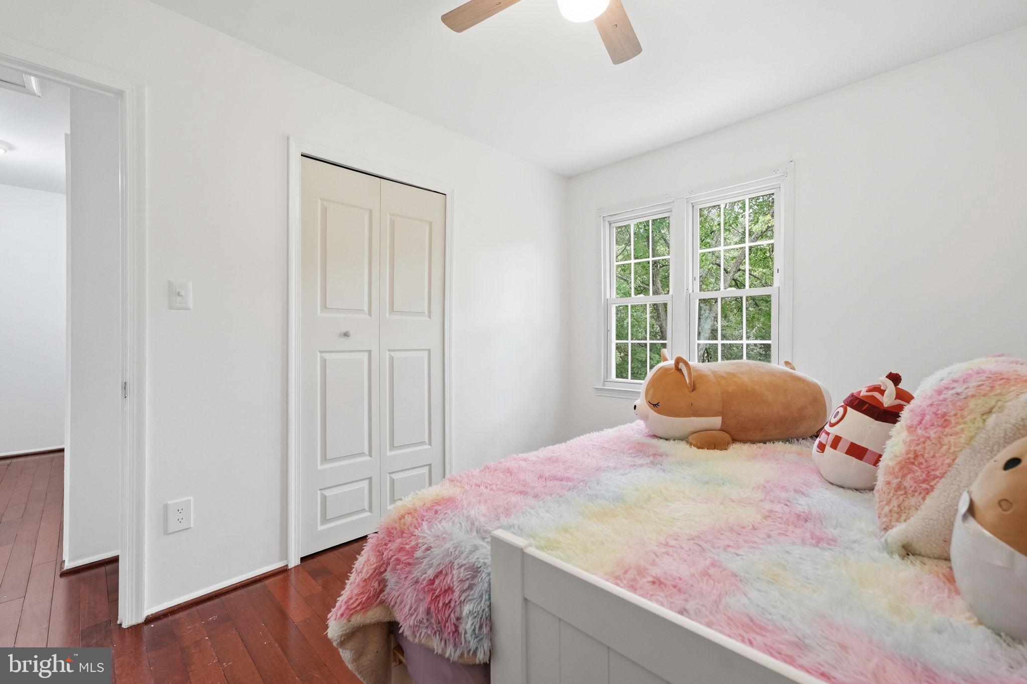 8260 Getty Court Springfield, VA 22153 - Photo 18 of 31 a bedroom with a bed and wooden floor