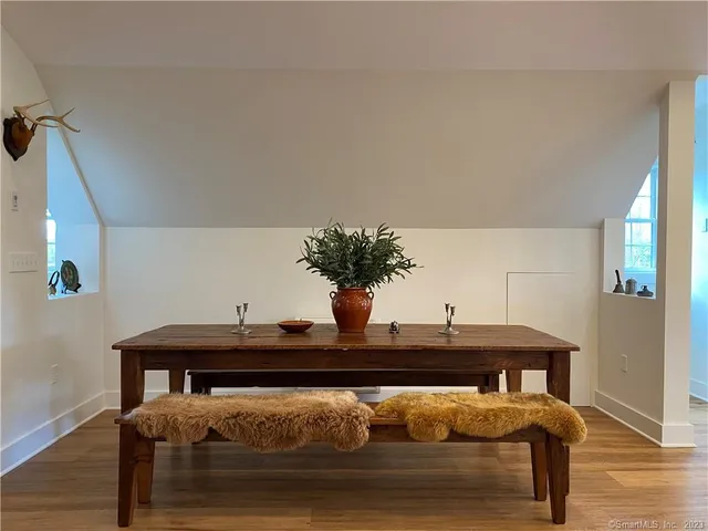 a living room with furniture and flowers