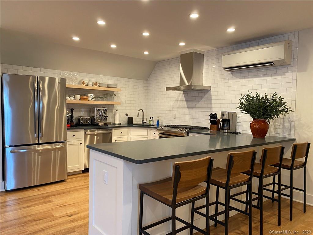 55 Still Meadow Road Sharon, CT 06069 - Photo 14 of 22 a kitchen with stainless steel appliances a sink and a refrigerator