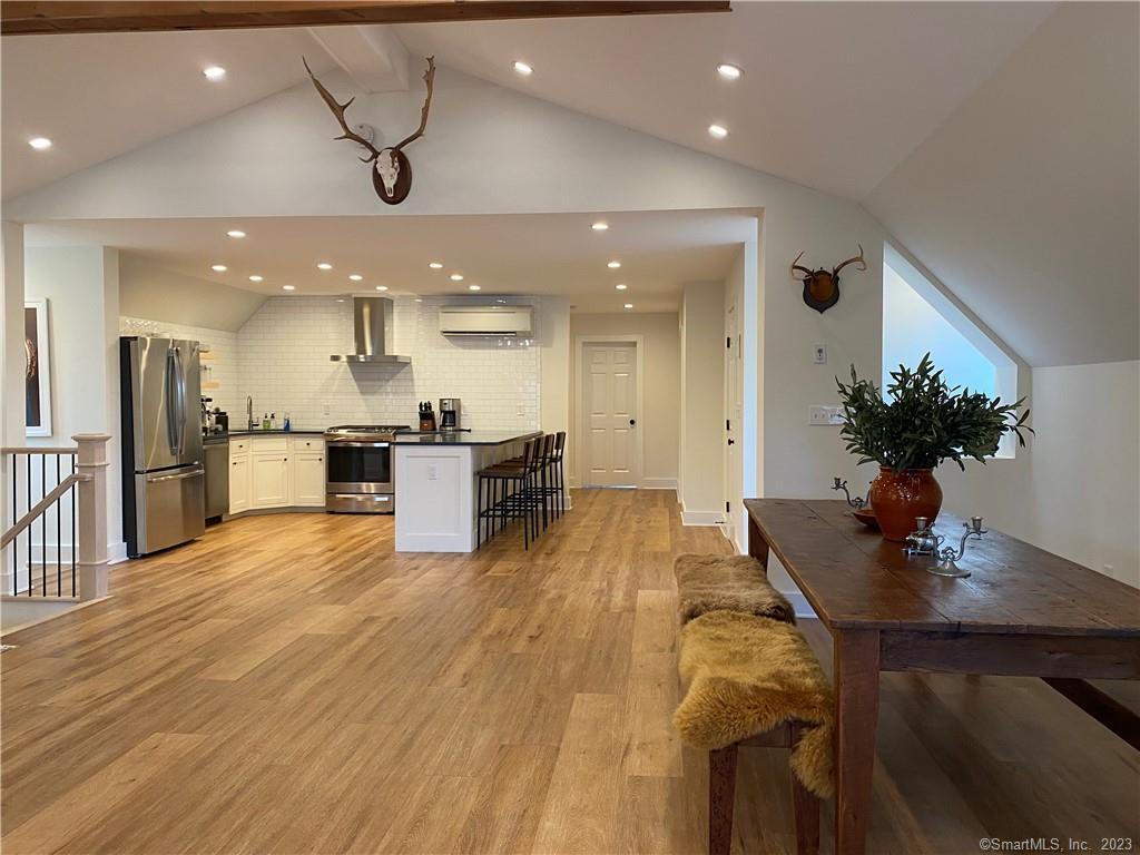 55 Still Meadow Road Sharon, CT 06069 - Photo 16 of 22 a room with stainless steel appliances kitchen island granite countertop a sink and a refrigerator
