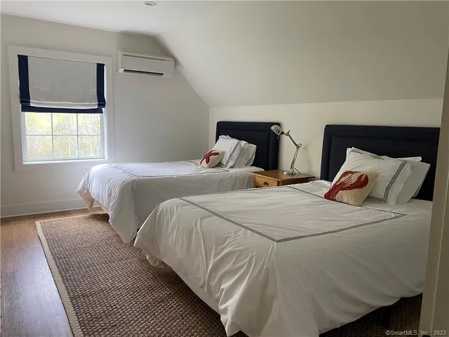 a bedroom with a bed and window