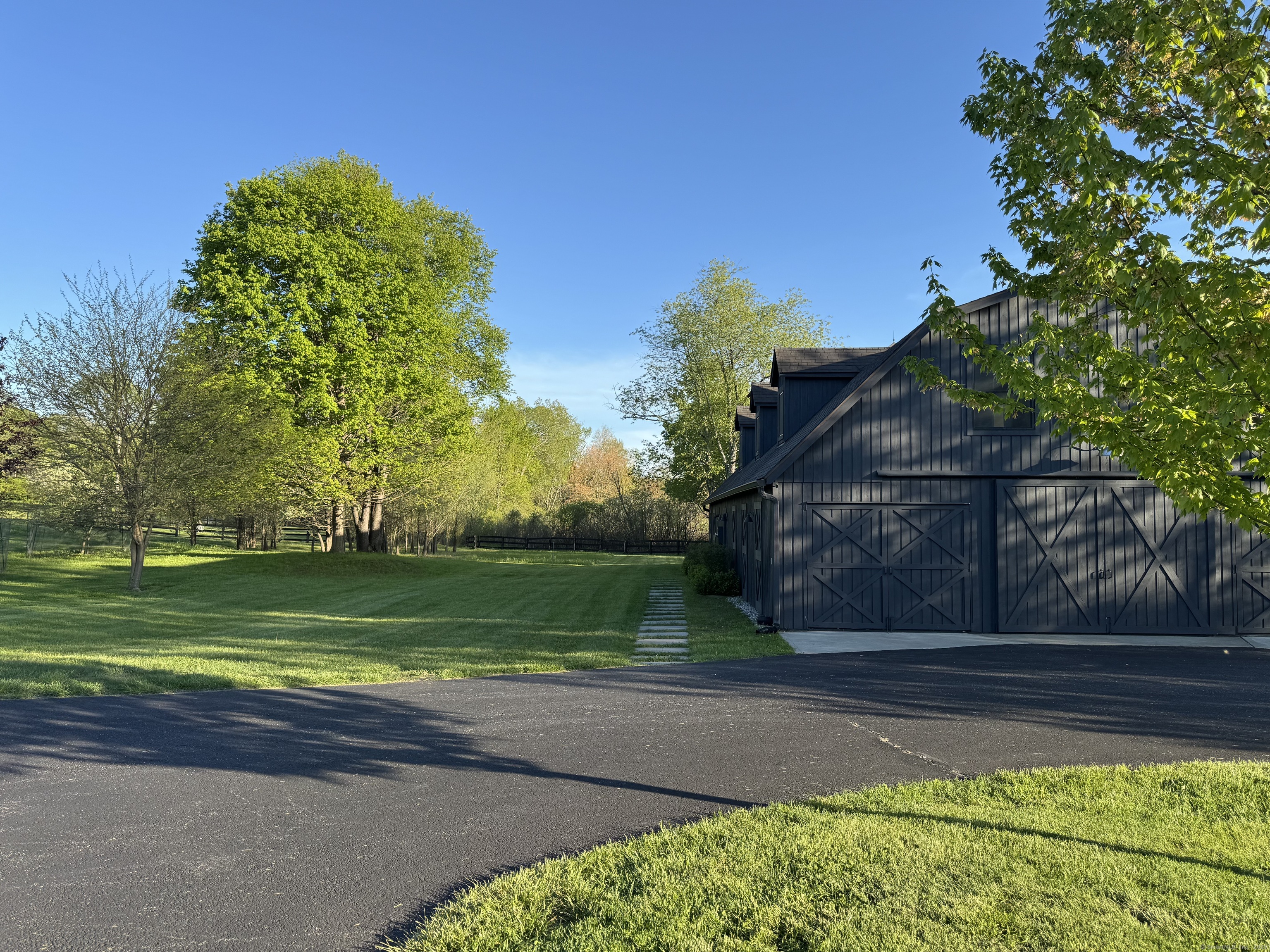 55 Still Meadow Road Sharon, CT 06069 - Photo 3 of 22 a front view of a house with a yard