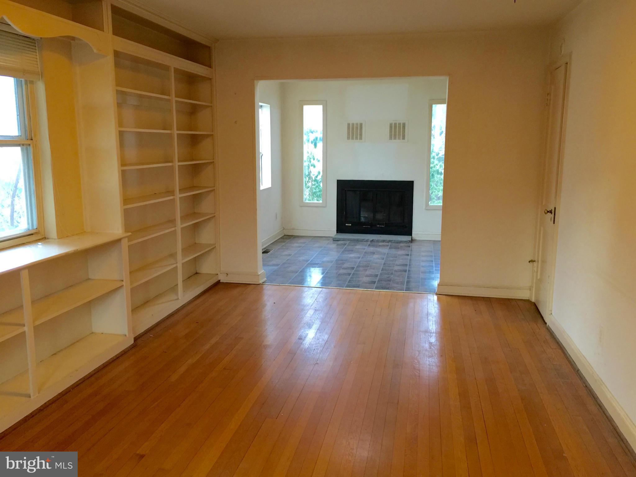 4915 Redford Road Bethesda, MD 20816 - Photo 4 of 15 a view of empty room with wooden floor and fireplace