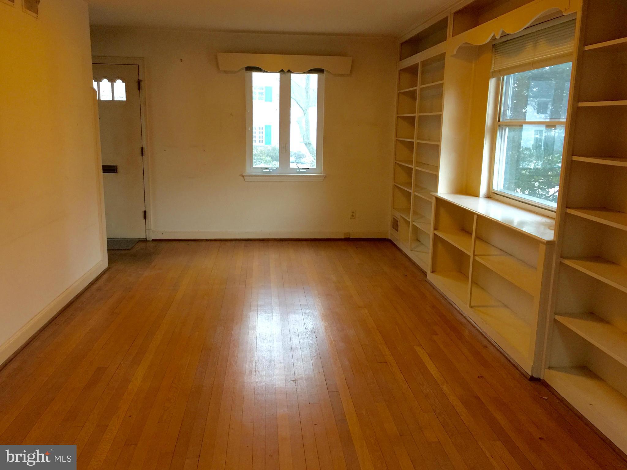 4915 Redford Road Bethesda, MD 20816 - Photo 5 of 15 a view of an empty room with wooden floor and a window