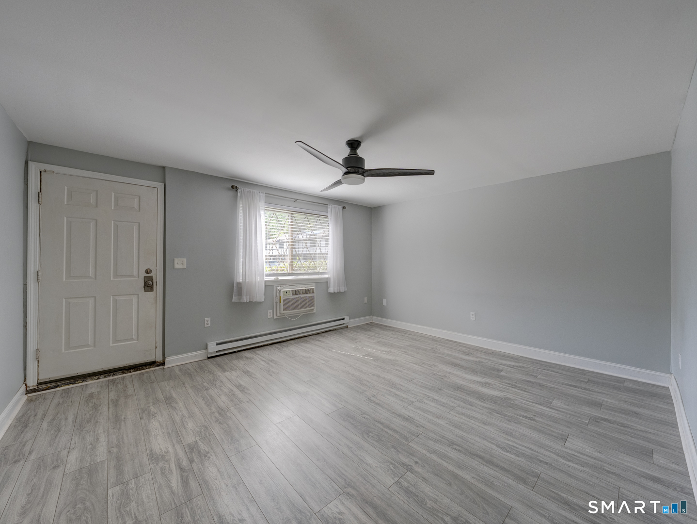 2 Branch Road, Unit 2C Thomaston, CT 06787 - Photo 3 of 26 wooden floor in an empty room with a window
