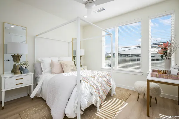 a bedroom with a bed and a potted plant