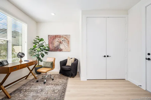 a living room with furniture and a potted plant