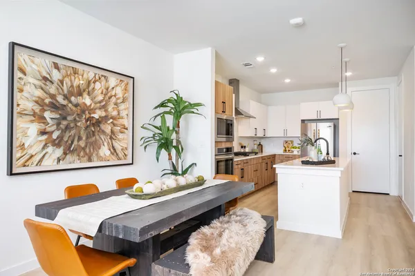 a living room with kitchen island furniture and a wooden floor
