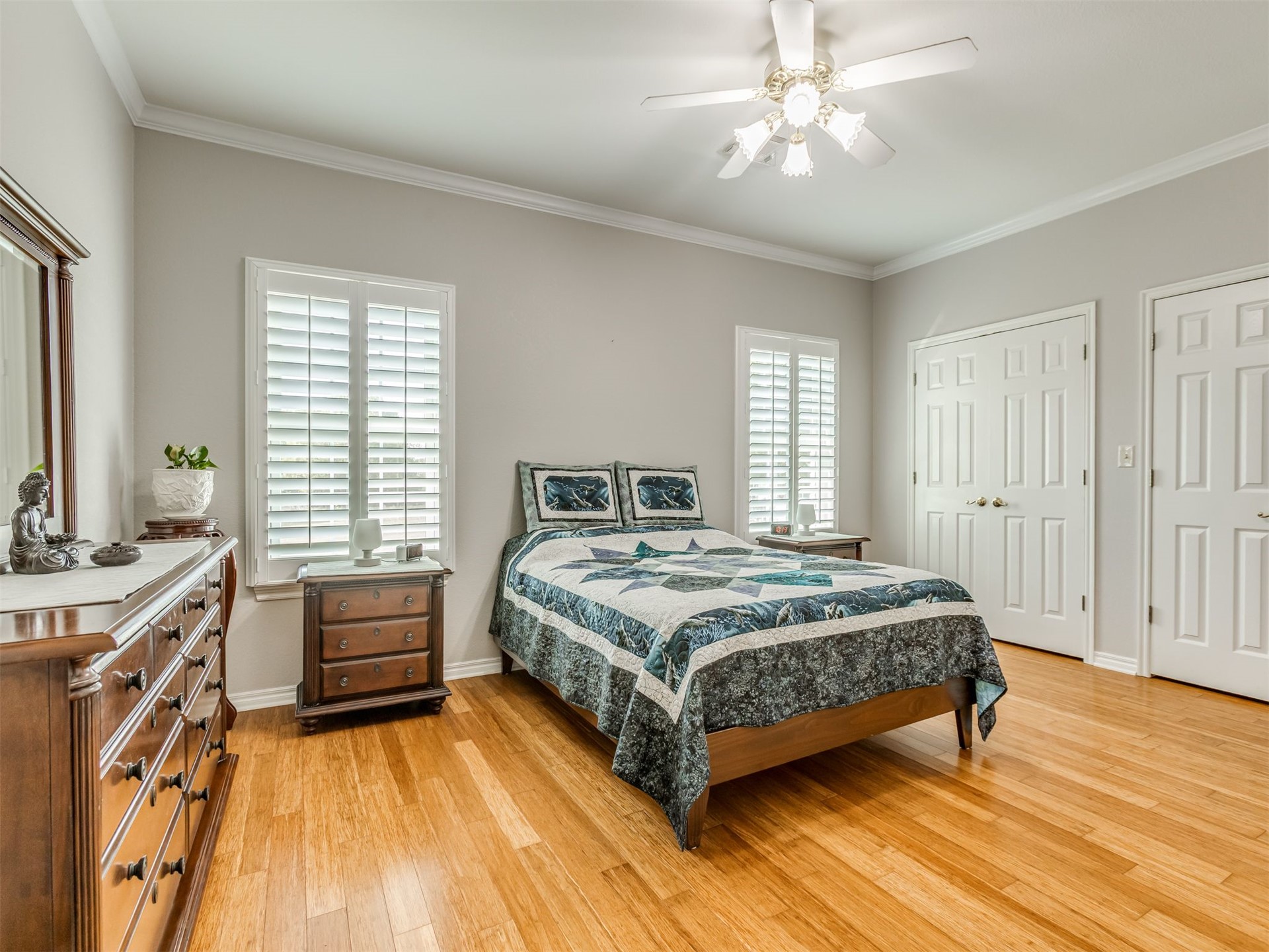 119 Mainsail Road Stigler, OK 74462 - Photo 21 of 52 Wood-finish flooring, crown molding, plantation shutters, multi-panel doors, and a ceiling fan with integrated lighting