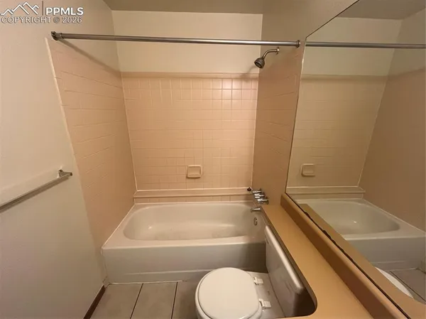 a bathroom with a tub and a shower