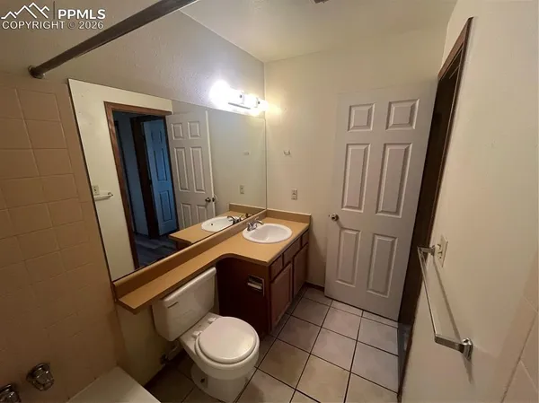 a bathroom with a sink a toilet and mirror