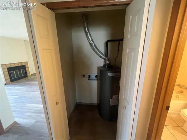 a view of hallway with wooden floor and stairs