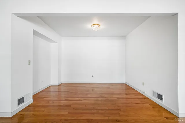 a view of a room with wooden floor