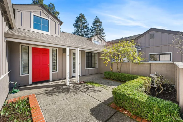 a view of a house with backyard and porch