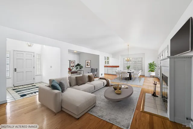 a view of a kitchen with wooden floor and a refrigerator