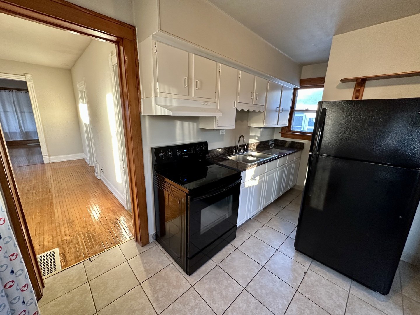633 Chester Avenue Elgin, IL 60120 - Photo 11 of 29 a kitchen with granite countertop a refrigerator a stove a microwave and cabinets