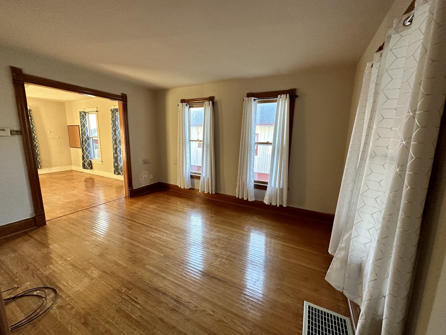 633 Chester Avenue Elgin, IL 60120 - Photo 2 of 29 a view of an empty room with wooden floor and a window