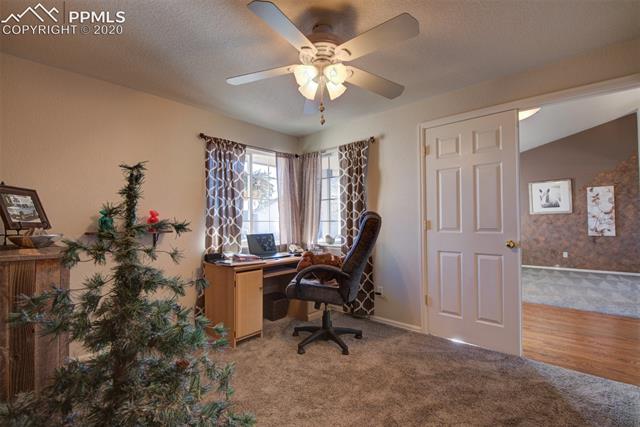 7828 Bullet Road Peyton, CO 80831 - Photo 20 of 32 Bedroom 3 on Main Level. Can be used for office, or den. Notice the French Doors coming in from the front room.