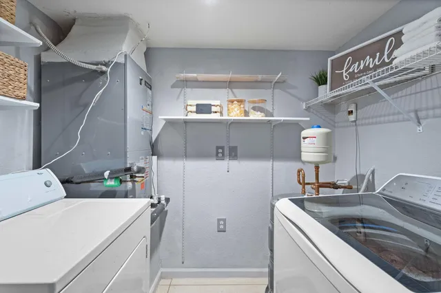 a kitchen with a sink cabinets and appliances