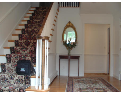 249 Rice Road Wayland, MA 01778 - Photo 13 of 26 a view of a hallway with entryway wooden floor and front door