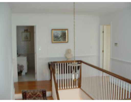 249 Rice Road Wayland, MA 01778 - Photo 14 of 26 a view of a hallway with wooden floor and a bathroom