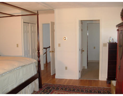 249 Rice Road Wayland, MA 01778 - Photo 15 of 26 a bedroom with a bed and a glass door shower