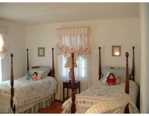 249 Rice Road Wayland, MA 01778 - Photo 18 of 26 a bedroom with a bed and a chandelier