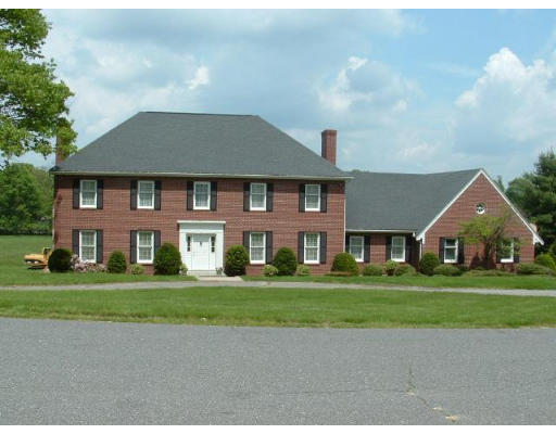 249 Rice Road Wayland, MA 01778 - Photo 25 of 26 a front view of a house with a garden