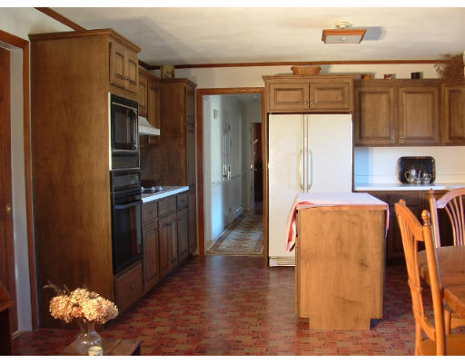 249 Rice Road Wayland, MA 01778 - Photo 9 of 26 a kitchen with stainless steel appliances kitchen island granite countertop a refrigerator and a stove