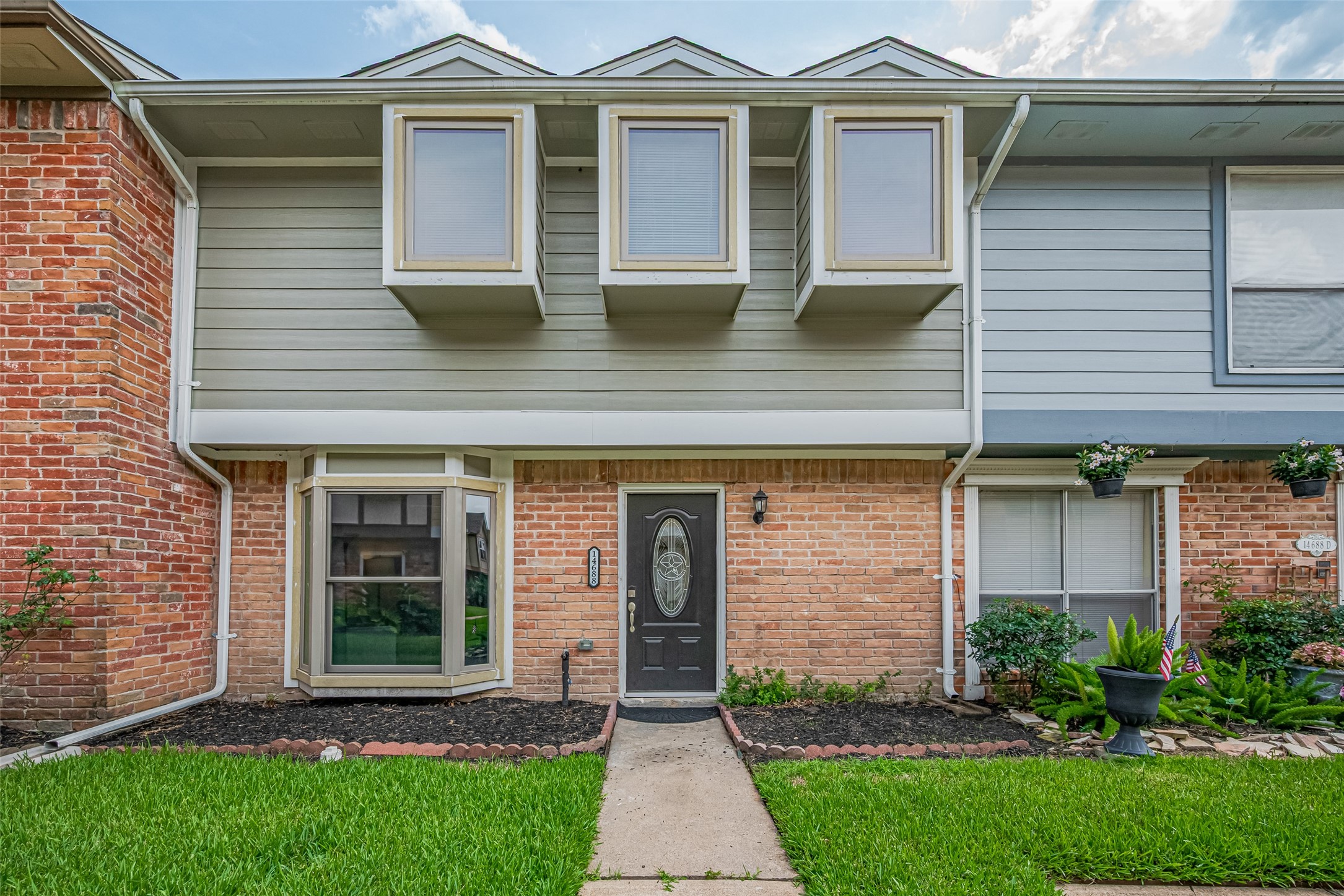 14688 Perthshire Road, Unit C Houston, TX 77079 - Photo 1 of 42 a front view of a house with garden