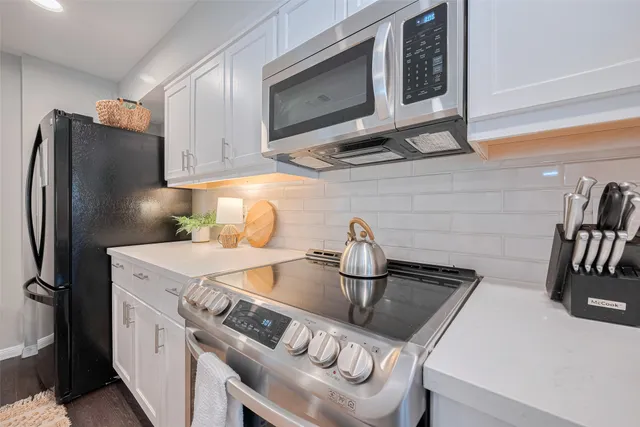 a kitchen with stainless steel appliances a sink a stove and refrigerator