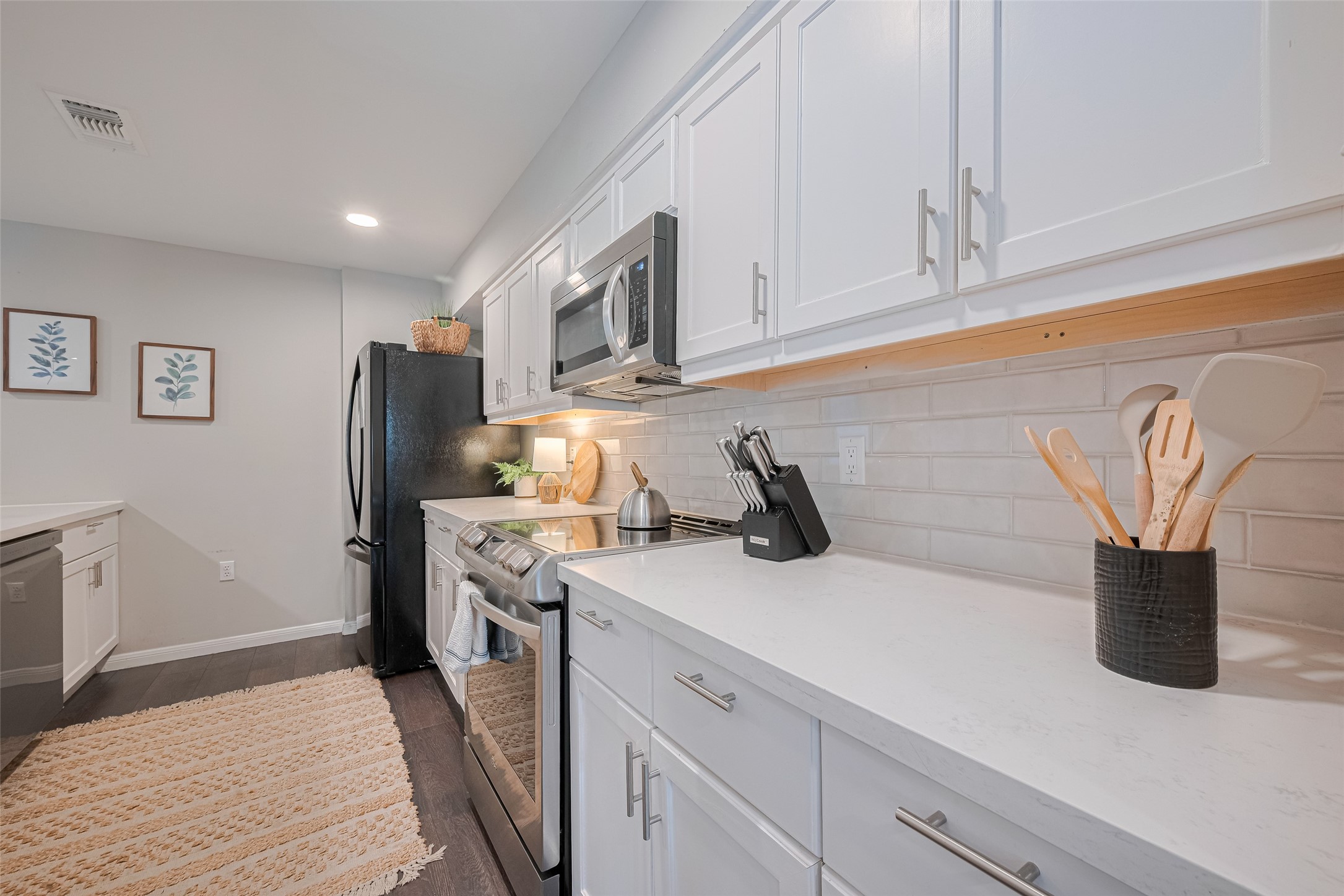 14688 Perthshire Road, Unit C Houston, TX 77079 - Photo 13 of 42 a kitchen with a sink and a refrigerator