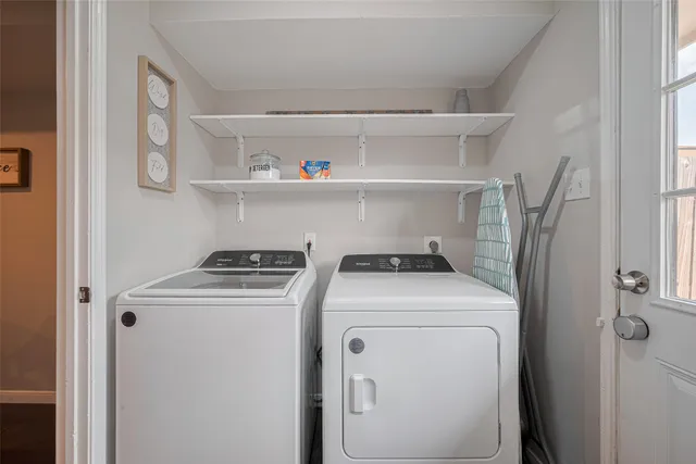 a view of washer and dryer with kitchen in the background